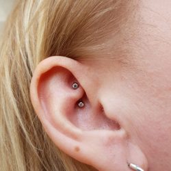 A teeny Neometal forward facing CZ gem rook piercing