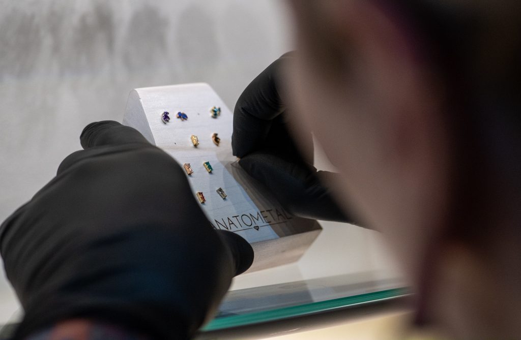 studio member putting jewellery onto a display