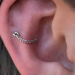 The Drip chain piece from Buddha jewellery, in a Snug location on the right ear. This client needed two piercings for this jewellery.
